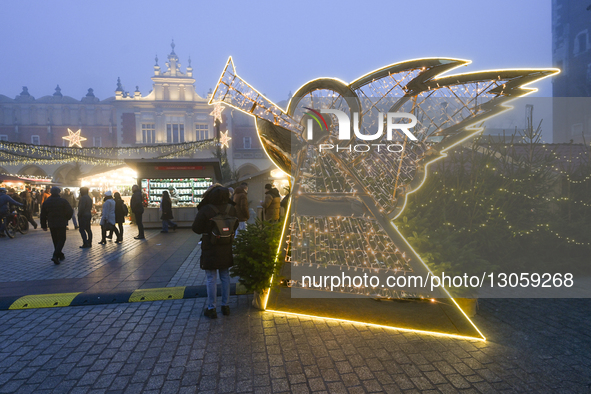 KRAKOW, POLAND – DECEMBER 4:
An angel figure illuminates Christmas decorations at the Christmas Market in Krakow’s Main Market Square amid d... by Artur Widak/NurPhoto