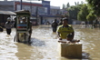 A child plays in the middle of a flood that hits Dayeuhkolot, Bandung Regency, West Java,...