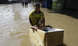A child plays in the middle of a flood that hits Dayeuhkolot, Bandung Regency, West Java,...
