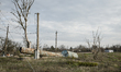 A water tower, toppled by Russian shelling, lies on the ground in Partyzanske village, whi...
