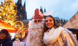 Nikolaus and an angel pose for pictures at the Cologne Christmas Market in Cologne, German...