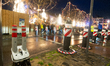 Anti-terror blockages are seen in front of the Christmas market as a crowd of people is se...