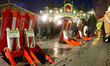 Anti-terror blockages are seen in front of the Christmas market as a crowd of people is se...