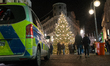 A police car is parked in front of a Christmas tree in Cologne, Germany, on December 6, 20...