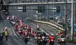 Hundreds of motorcycle drivers dressed as Santa Claus drive to the pediatric hospital to o...
