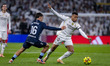 Kylian Mbappe of Real Madrid is in action with the ball, defended by Miguel Roman of RC Ce...