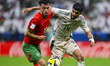 Amin Zahzouk of Morocco and Waleed Alahmad of Saudi Arabia play during the Group B FIFA Ar...