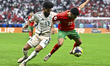 Karim El Berkaoui of Morocco and Nawaf Bu Washl of Saudi Arabia are in action during the G...