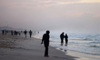 Palestinians spend their time on the Mediterranean coast during sunset in Gaza City, on De...