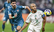 Yacine Brahimi of Algeria and Ahmed Hasan of Iraq are in action during the Group D FIFA Ar...