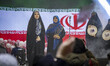Iranian woman Fatemeh Rezaie stands in front of a display depicting the national flag afte...