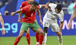 Mohamed Rabie Hrimat of Morocco and Mahmoud Alaswad of Syria are in action during the FIFA...