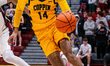 Jamari Piercy, 14, of the Coppin State Eagles drives the ball during an NCAA men's basketb...