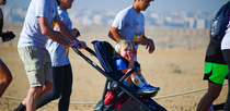 Editorial photo: A father participates with his young child in the Pyramids Half Marathon in Giza, Egypt, on December 13, 2025.  by Ahmed Mosaad/NurPhoto