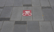 A bike path sign is painted on the sidewalk in Barcelona, Spain, on October 15, 2025. 