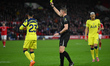 Referee Sam Barrott shows a yellow card to Pedro Porro of Tottenham Hotspur during the Pre...