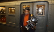 Cosplayer Louis Mendes poses for a photo with their cameras during the Holiday Nostalgia R...