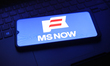 The MS NOW (My Source News Opinion World) logo appears on a smartphone screen in this illu...