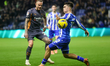 Craig Forsyth pushes the ball past Harry Amass during the Sky Bet Championship match betwe...