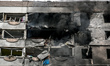 Black smoke rises from burning apartments in a residential building hit by a Russian guide...