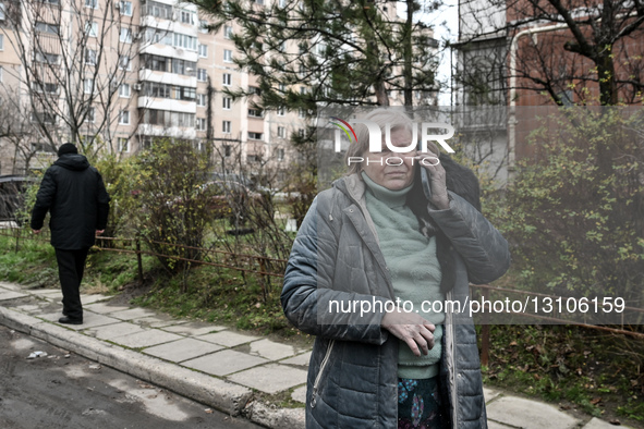 A woman with a cat on her shoulder talks on the phone after a Russian air strike in Zaporizhzhia, Ukraine, on December 17, 2025.  by Dmytro Smolienko/Ukrinform/NurPhoto