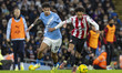 Nico O'Reilly #33 of Manchester City F.C. tackles Kevin Schade #7 of Brentford F.C. during...