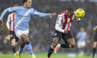 Rico Henry #3 of Brentford F.C. heads the ball forward during the Carabao Cup Quarter Fina...