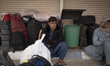An Afghan refugee sits beside his belongings in the Milak refugee camp on Iran's eastern b...