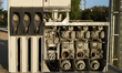 Internal pumps, motors, and belt-driven mechanisms of a fuel dispenser are seen at an aban...