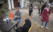 An Iranian Baluch man and his young veiled girl eat fast food at an outdoor fast food rest...