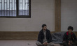 Two Afghan refugees sit in the Alghadir Refugee Camp located in the suburb of the border c...