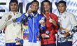 Eumir Felix Marcial of the Philippines, the gold medalist, celebrates on the podium with M...