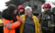 First responders assist a woman injured in Russian shelling in Zaporizhzhia, Ukraine, on D...