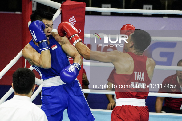Bunjong Sinsiri of Thailand competes against Tan Jun Jie Velvan of Singapore during the Men's welterweight 69kg finals - Gold medal boxing m... by Anusak Laowilas/NurPhoto