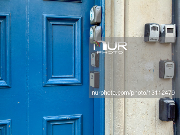 Multiple combination key boxes used for guest access to Airbnb, Booking.com, and other short-term rental apartments are attached to the door... by Michael Nguyen/NurPhoto