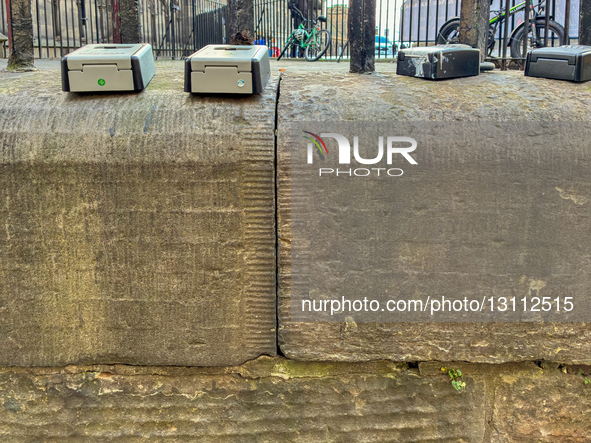Multiple combination key boxes used for guest access to Airbnb, Booking.com, and other short-term rental apartments are attached to a street... by Michael Nguyen/NurPhoto