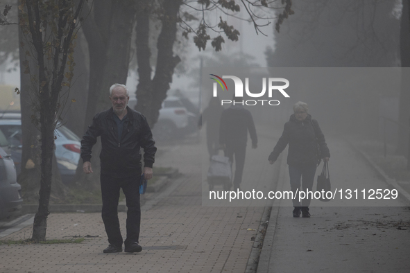 Local residents are on Milosa Bajica Street during fog in Novi Sad, Serbia, on December 9, 2023.  by Maxim Konankov/NurPhoto
