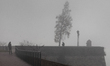 People walk at the Petrovaradin Fortress during fog in Novi Sad, Serbia, on December 9, 20...