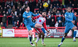 Jamie Reid, 19, from Stevenage, is challenged by George Evans of Burton Albion during the...