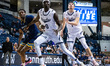 DOK MUORDAR (0) of the Monmouth Hawks goes to rebound during an NCAA men's basketball game...