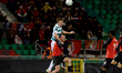 Daniel Cleary of Shamrock Rovers heads the ball ahead of Nikolai Micallef of Hamrun Sparta...
