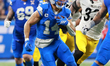 DETROIT,MICHIGAN-DECEMBER 21: Detroit Lions wide receiver Amon-Ra St. Brown #14 runs the b...