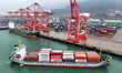 A cargo ship docks at a port berth to load and unload containers in Lianyungang, Jiangsu P...