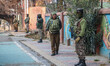 Indian security personnel guard outside the Holy Family Catholic Church during Christmas D...