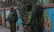 Indian security personnel guard outside the Holy Family Catholic Church during Christmas D...