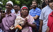 Relatives of a hostage seeking news of their loved one are seen walking away from an upsca...