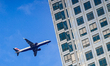 A British Airways Embraer 190 aircraft, operated by BA CityFlyer, flies at low altitude pa...