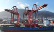 A cargo ship docks at the berth for loading and unloading containers at the container term...