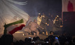 Iranian artists perform in an anti-Israeli piece during an unveiling ceremony of a statue...