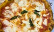 A traditional Neapolitan Margherita pizza, made with tomato sauce, mozzarella, olive oil,...